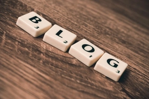 Scrabble-style tiles spelling 'BLOG' on a wooden surface—symbolizing strategic content creation that informs, engages, and builds trust with local audiences